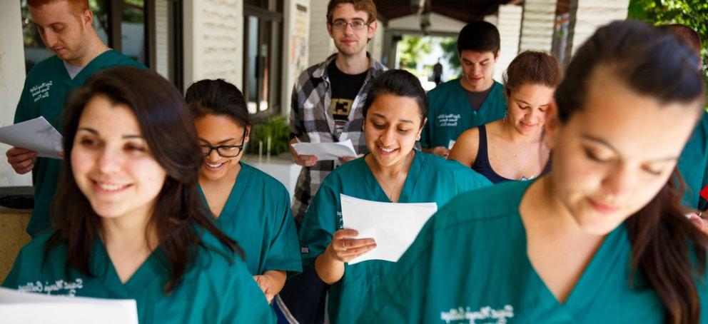 students in scrubs walking the halls of saint mary's